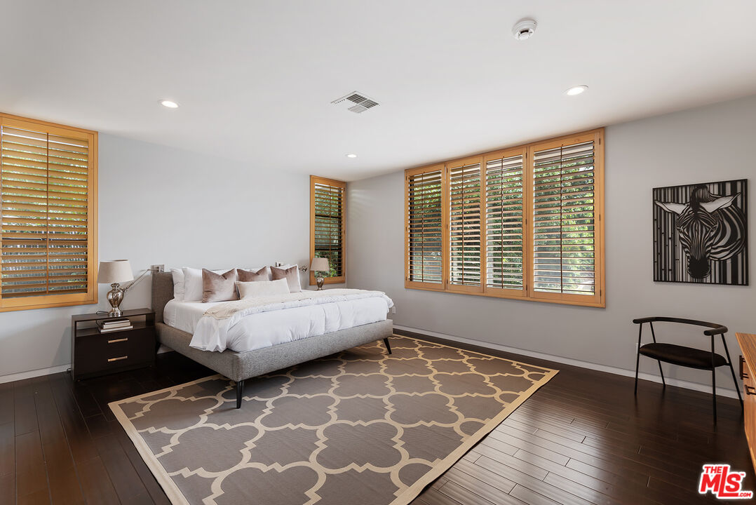 1018 Summit Drive Beverly Hills, CA 90210 - Photo 15 of 21 a bedroom with furniture and window