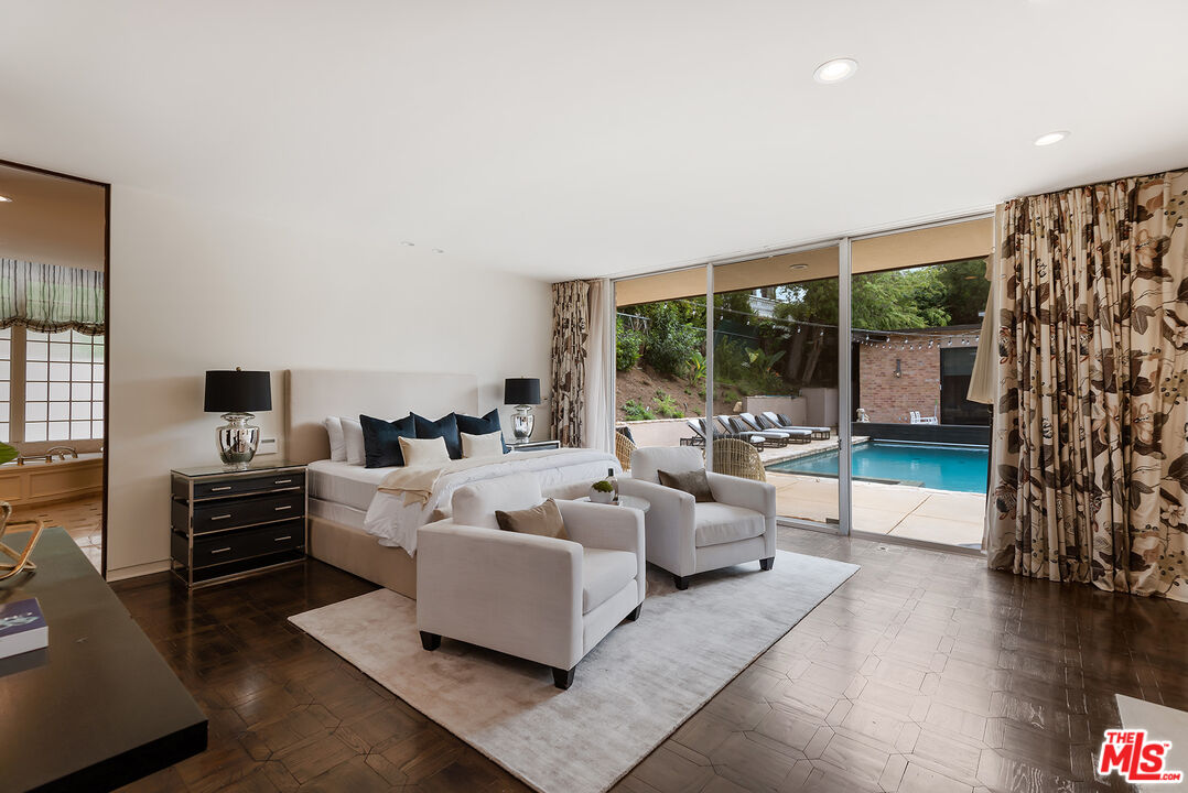 1018 Summit Drive Beverly Hills, CA 90210 - Photo 16 of 21 a living room with furniture and a flat screen tv