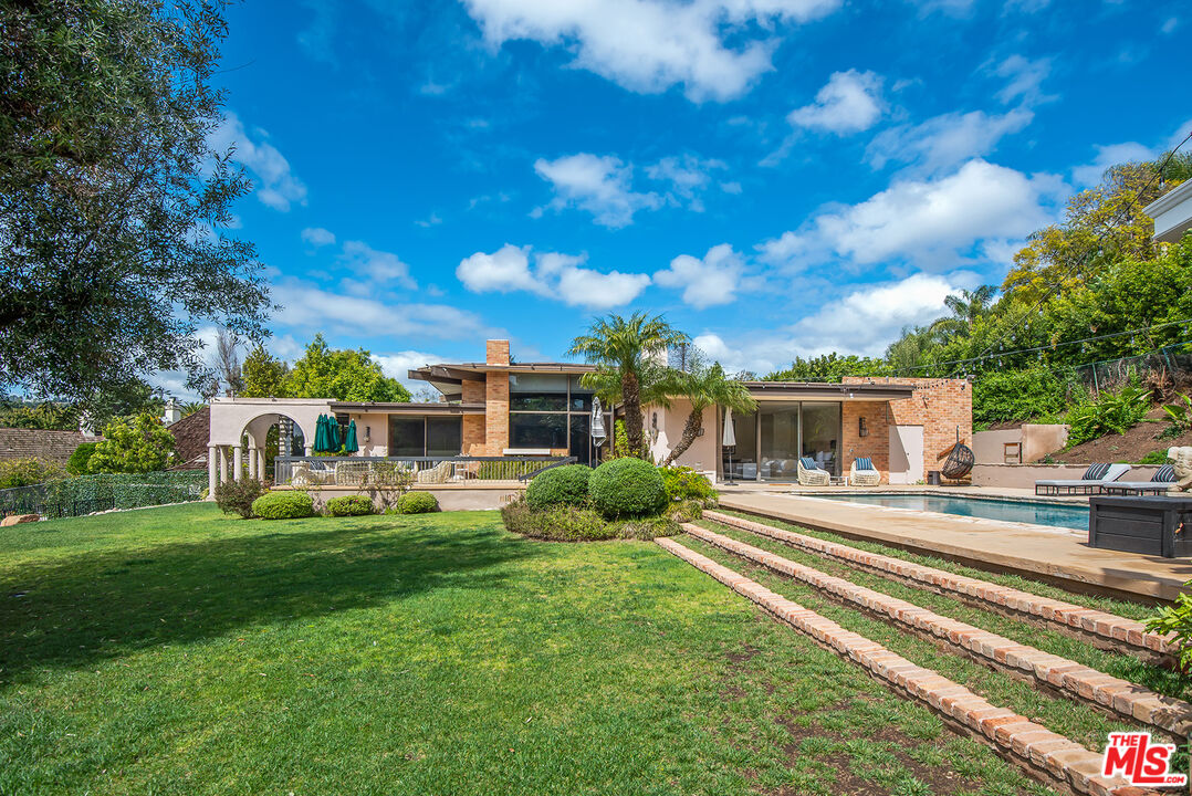 1018 Summit Drive Beverly Hills, CA 90210 - Photo 21 of 21 a front view of a house with garden