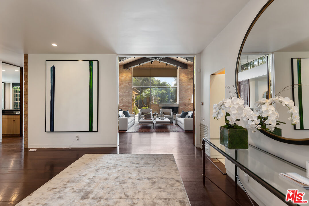 1018 Summit Drive Beverly Hills, CA 90210 - Photo 3 of 21 a living room with furniture and a potted plant