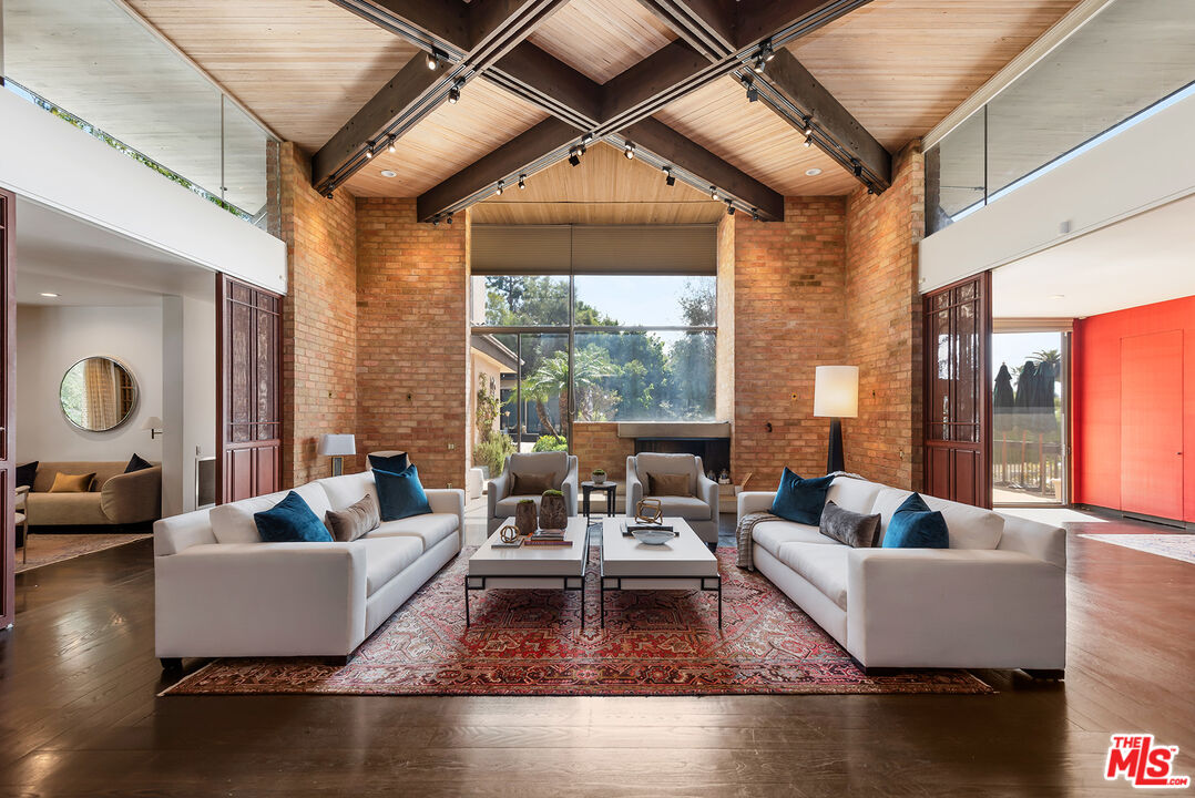 1018 Summit Drive Beverly Hills, CA 90210 - Photo 4 of 21 a living room with fireplace furniture and a large window