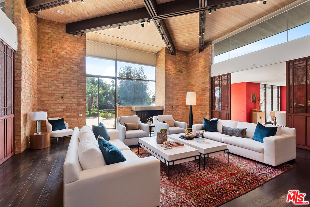 1018 Summit Drive Beverly Hills, CA 90210 - Photo 5 of 21 a living room with furniture wooden floor and a table