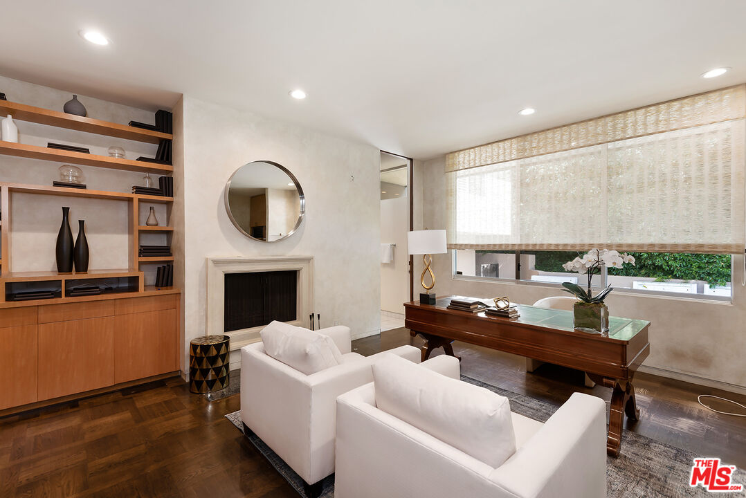 1018 Summit Drive Beverly Hills, CA 90210 - Photo 9 of 21 a living room with furniture and a fireplace
