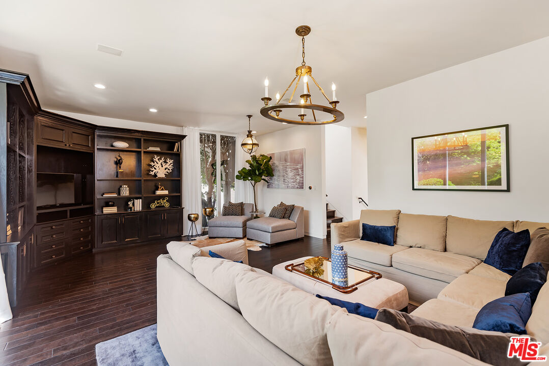 1018 Summit Drive Beverly Hills, CA 90210 - Photo 10 of 21 a living room with furniture and a flat screen tv
