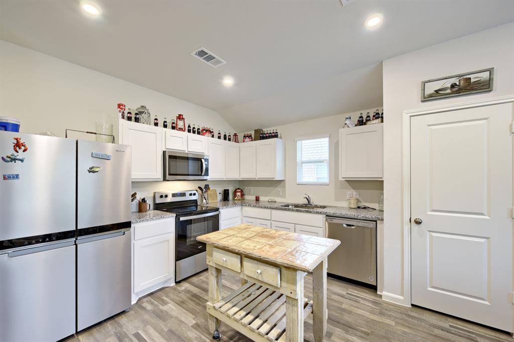 420 Jameson Springtown, TX 76082 - Photo 9 of 29 a kitchen with a refrigerator a stove and a microwave
