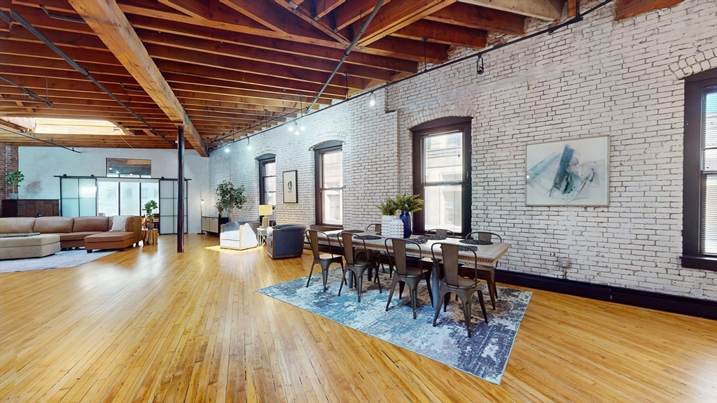 19 Stanhope Street, Unit 3A Boston, MA 02116 - Photo 16 of 19 a outdoor space with lots of furniture and wooden floor