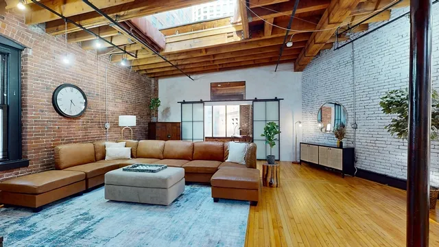 a living room with furniture and a clock