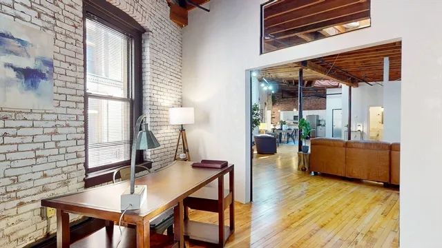 a dining room with furniture and wooden floor