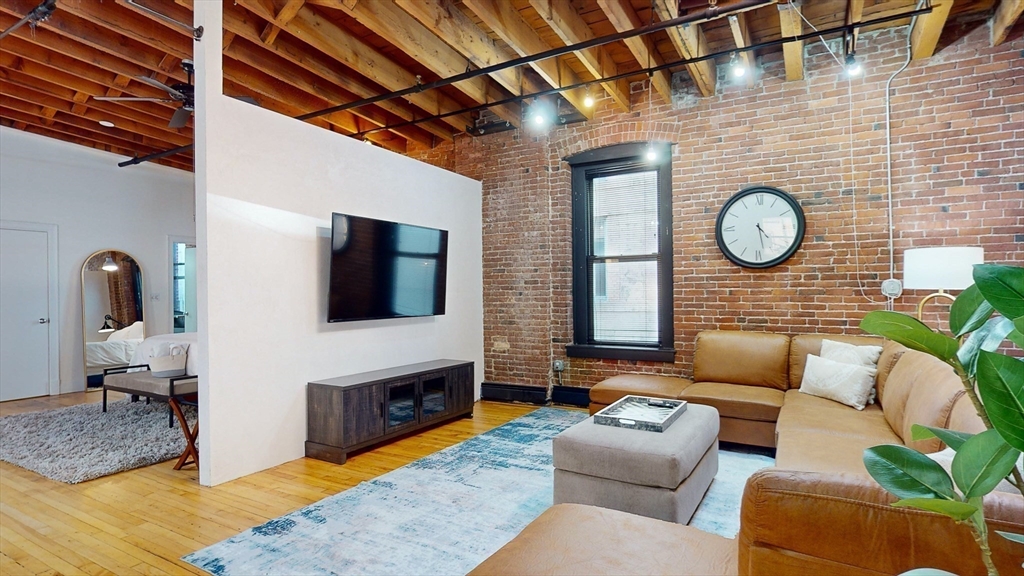 19 Stanhope Street, Unit 3A Boston, MA 02116 - Photo 9 of 19 a living room with furniture and a flat screen tv