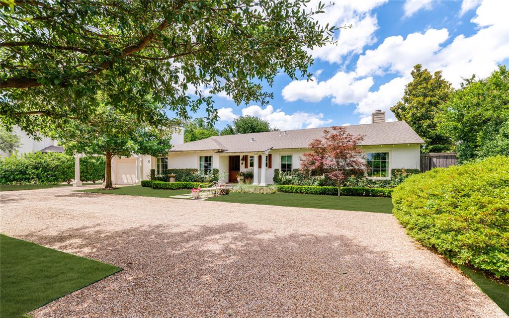 4407 Ridge Road Dallas, TX 75229 - Photo 1 of 32 a front view of a house with a garden and trees