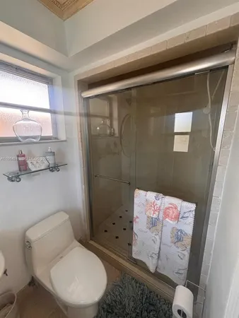 a bathroom with a toilet and shower