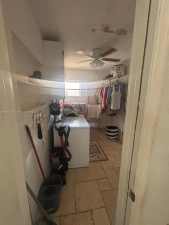 a storage room with water heater and racks