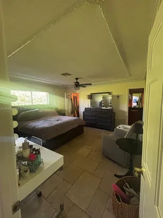 a bedroom with furniture and a flat screen tv