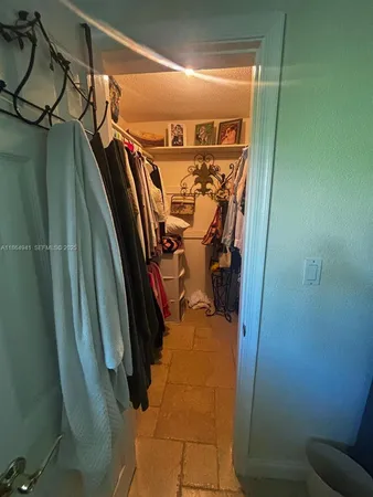 a bedroom with a bed and a television