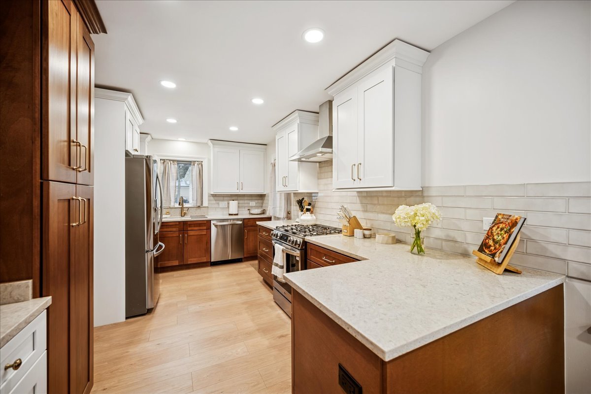 453 Longfellow Avenue Deerfield, IL 60015 - Photo 6 of 25 a kitchen with a refrigerator a sink a stove and cabinets