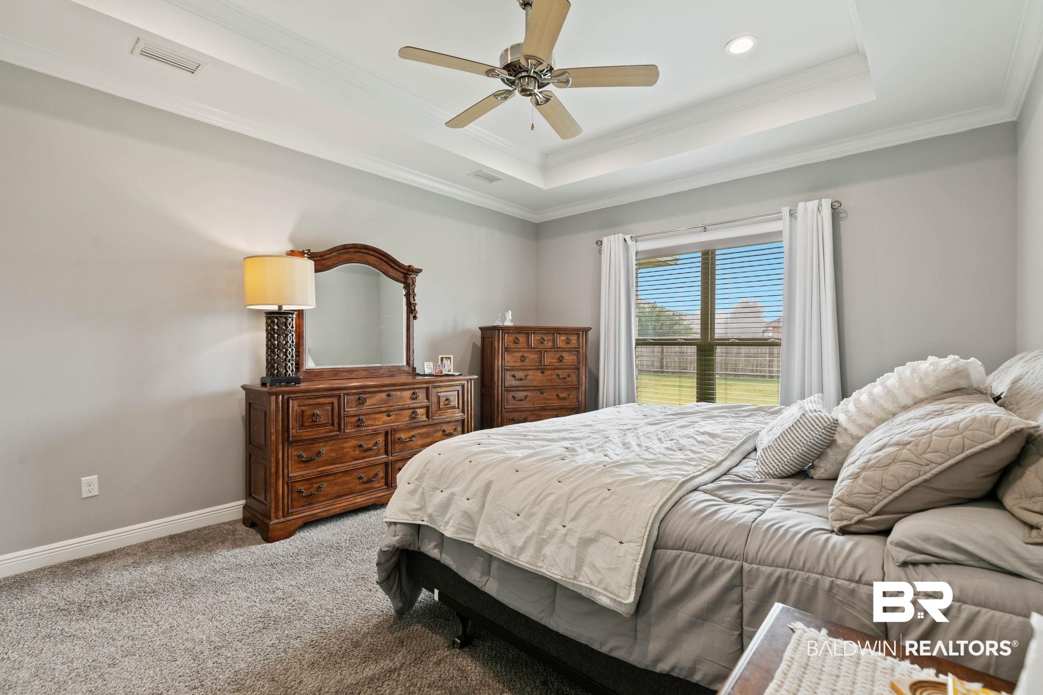 9388 Pembrook Loop Fairhope, AL 36532 - Photo 31 of 53 Bedroom with crown molding, a tray ceiling, carpet, and a ceiling fan