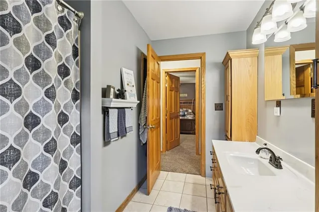 a bathroom with a tub sink and mirror