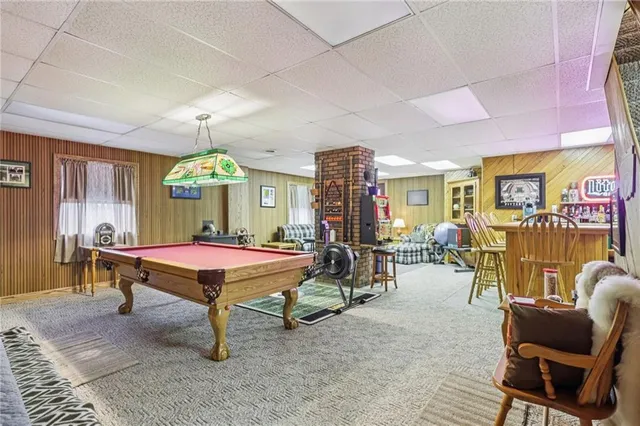 a living room with furniture a air conditioner and a window