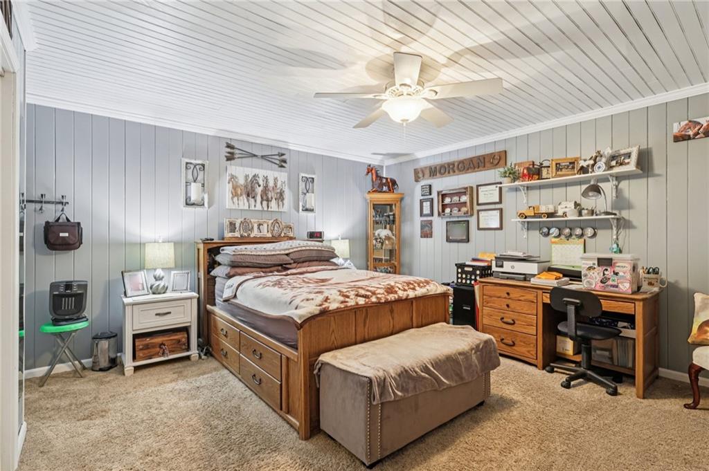 718 McDowell Road Volant, PA 16156 - Photo 20 of 34 a bedroom with a bed and a chandelier