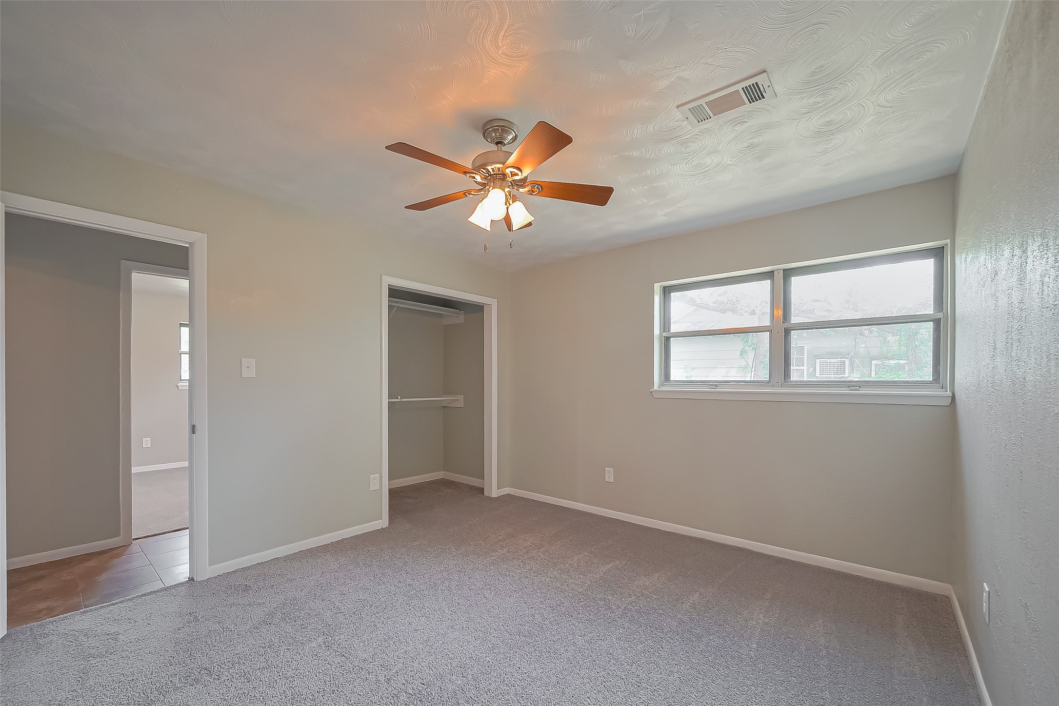 111 North 11th Street Highlands, TX 77562 - Photo 27 of 35 a view of a room with a ceiling fan and a window