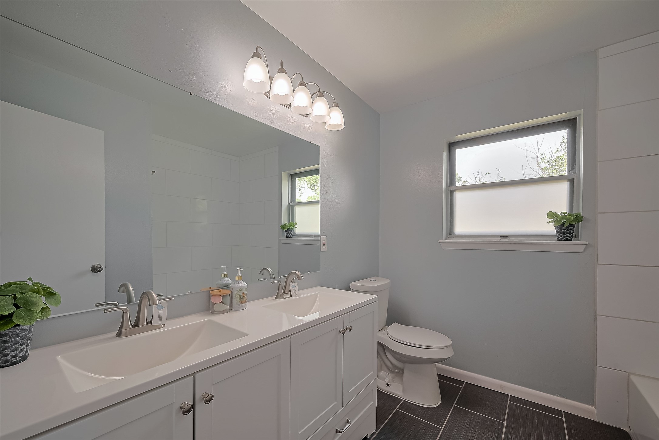111 North 11th Street Highlands, TX 77562 - Photo 29 of 35 a bathroom with a toilet sink and mirror