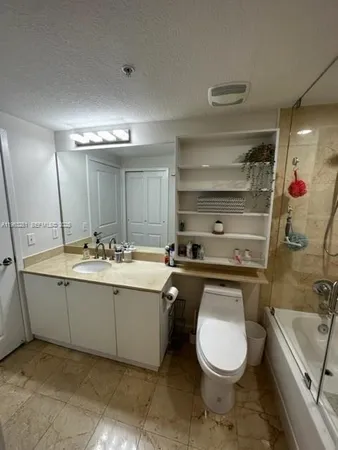 a bathroom with a sink a toilet and a bathtub
