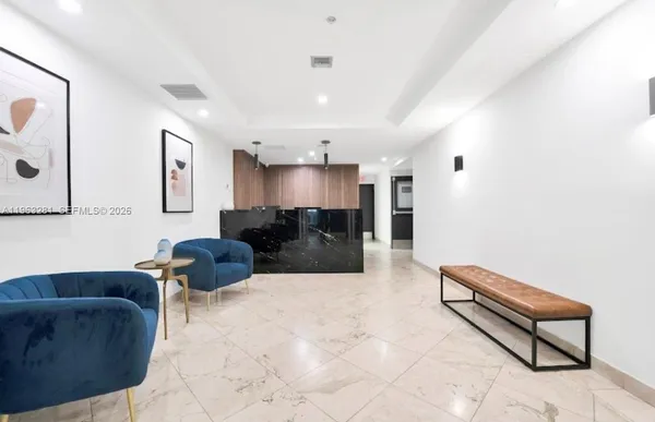 a living room with furniture and kitchen view
