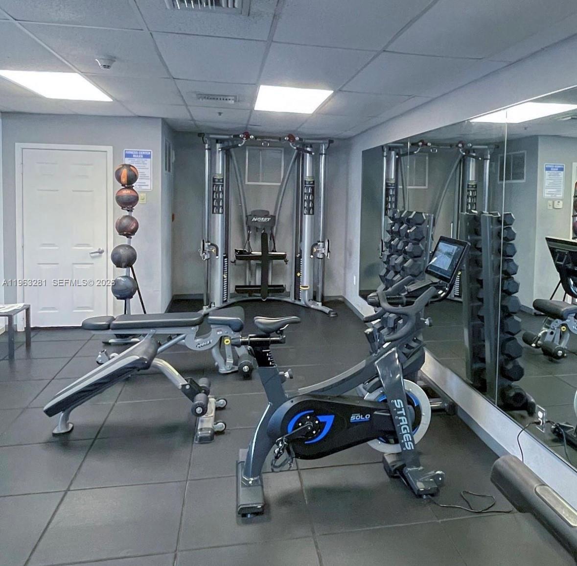 170 Southeast 14th Street, Unit 1606 Miami, FL 33131 - Photo 21 of 24 a room with gym equipment