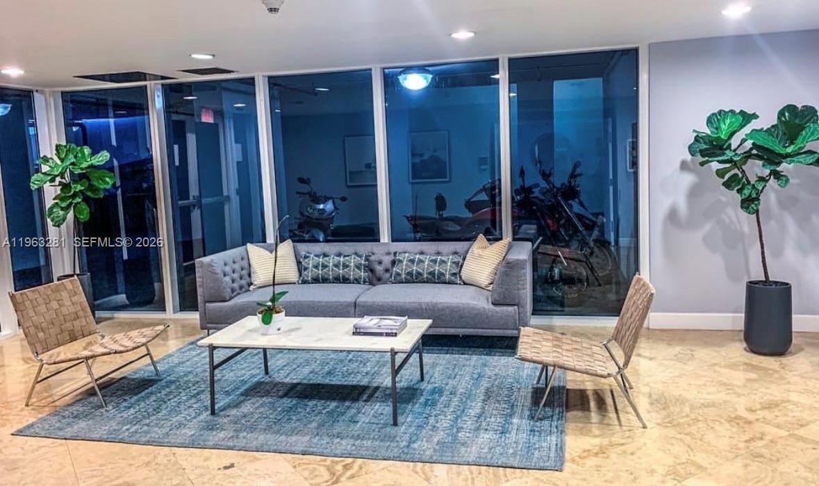 170 Southeast 14th Street, Unit 1606 Miami, FL 33131 - Photo 22 of 24 a living room with furniture potted plant and kitchen view