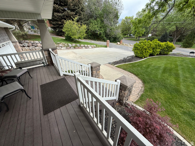 1360 Carterville Road Orem, UT 84097 - Photo 33 of 41 Front porch with composite decking, white railing, and stone-clad columns
