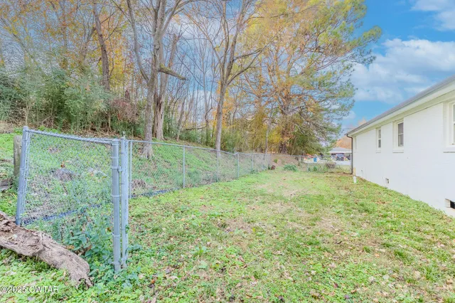 a view of a small house with a small barn