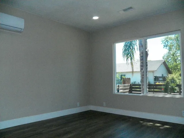 a view of wooden floor and windows in a room