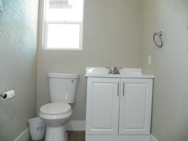 a bathroom with a sink a toilet and mirror