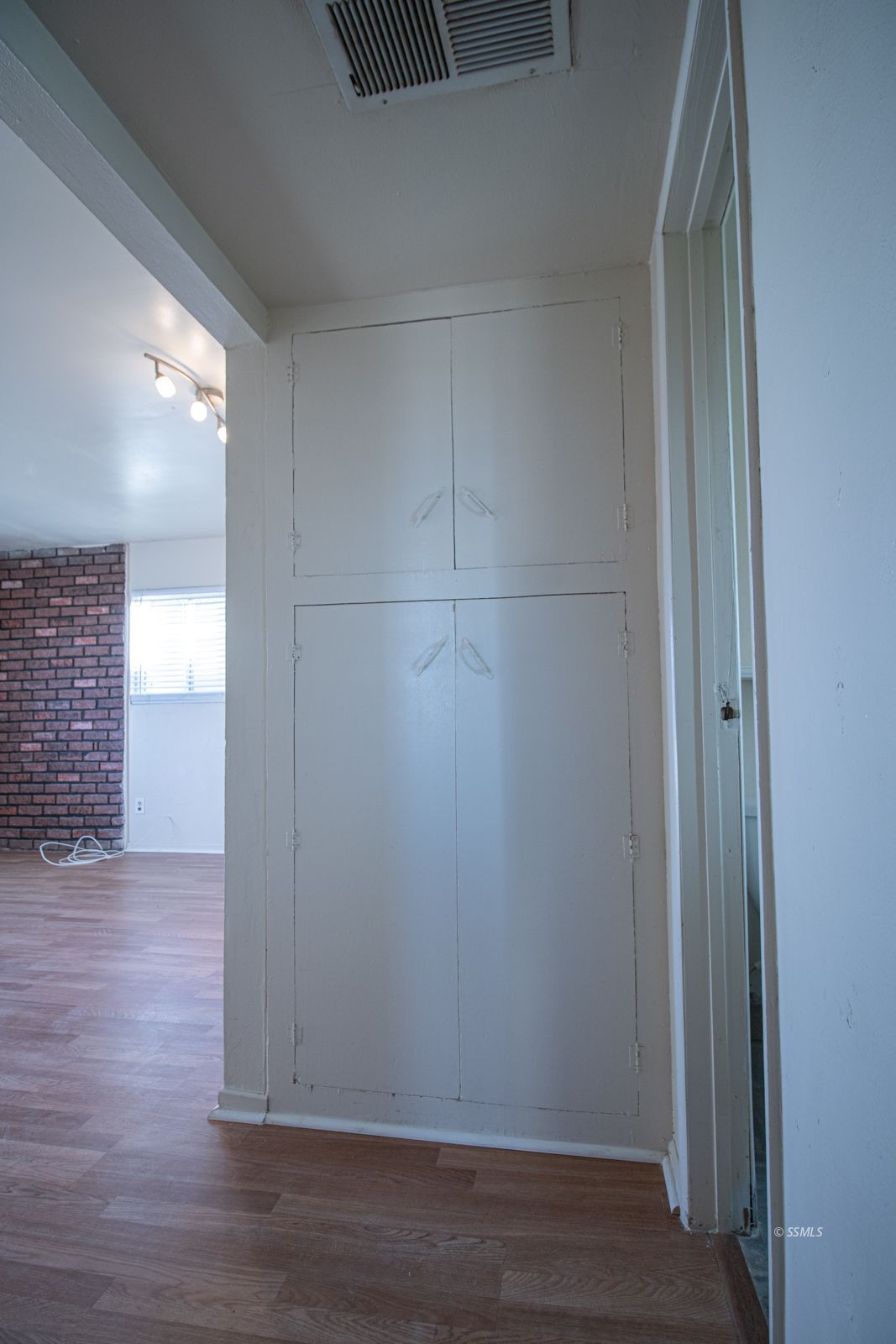 1621 Sims Street Ridgecrest, CA 93555 - Photo 12 of 24 an empty room with wooden floor and windows