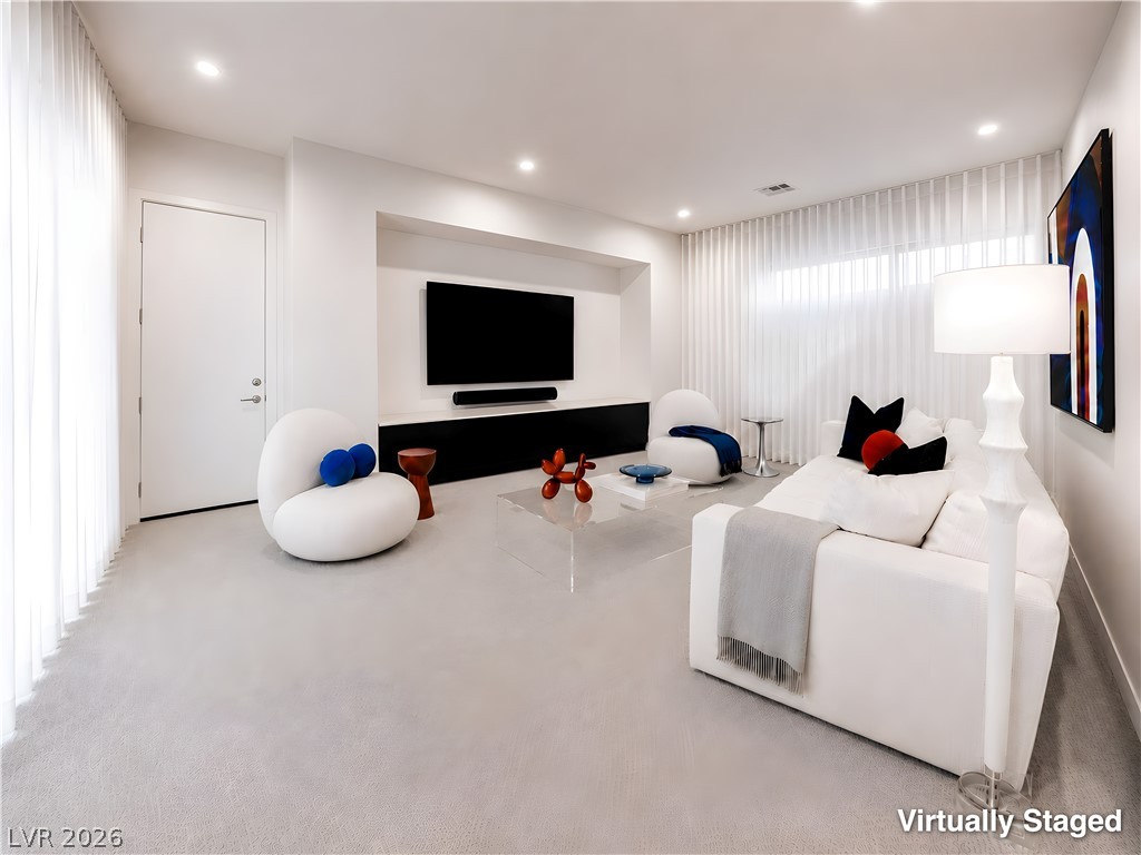25 Falling Ridge Lane Henderson, NV 89011 - Photo 7 of 48 Minimalist living area featuring recessed lighting and plush carpet, perfect for modern living.