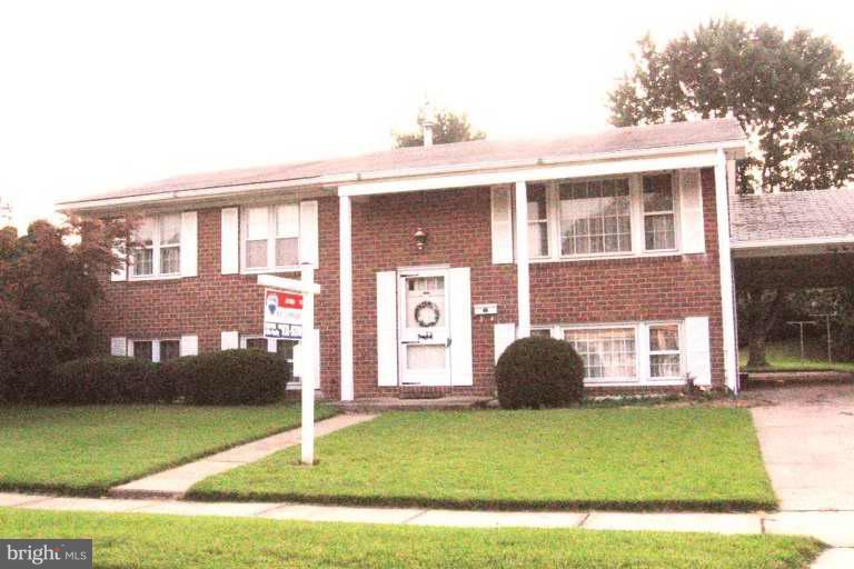 6210 Commons Road Rosedale, MD 21237 - Photo 1 of 1 a front view of a house with a garden