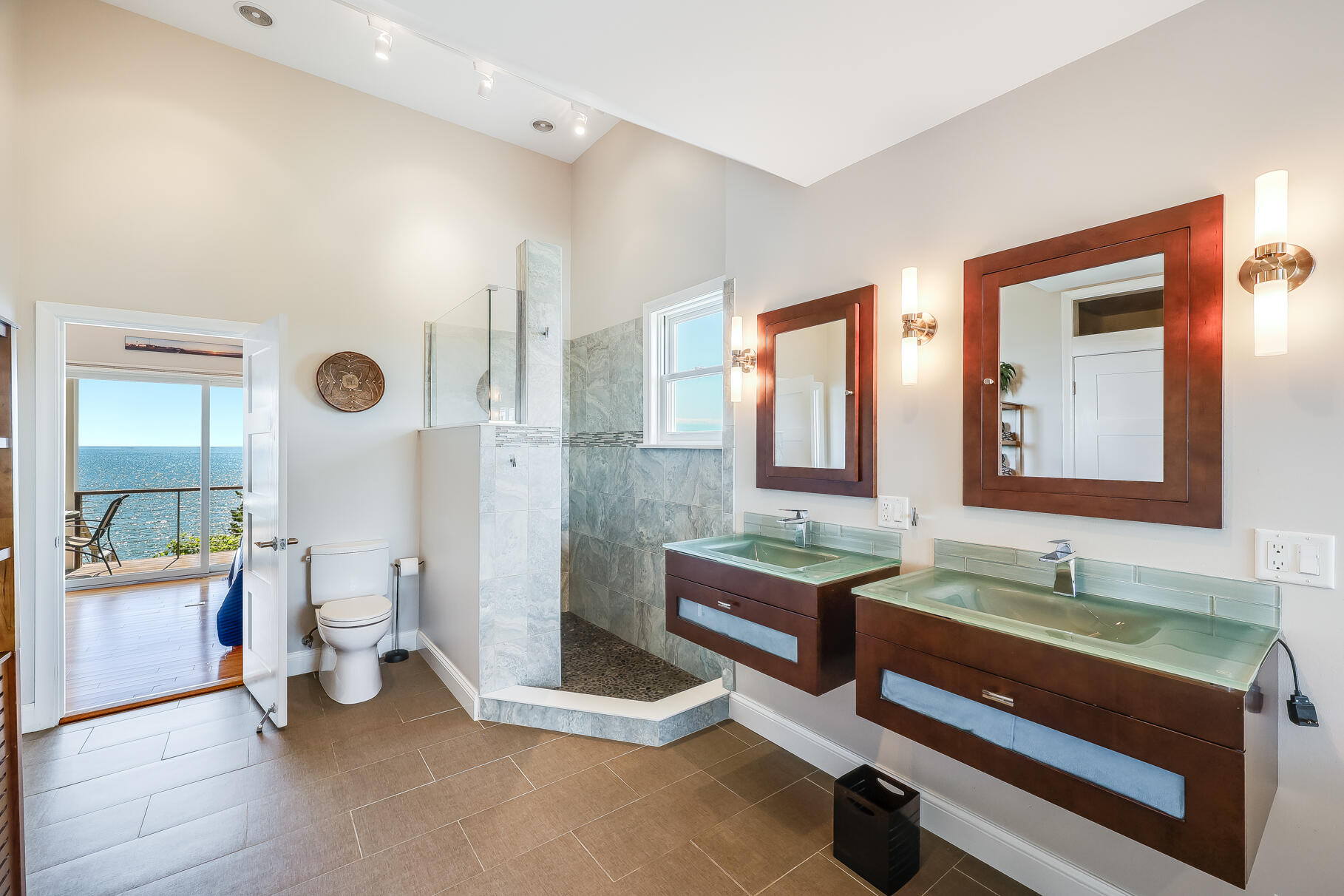 114 4th Street Wellfleet, MA 02667 - Photo 11 of 16 a spacious bathroom with a double vanity sink and a mirror