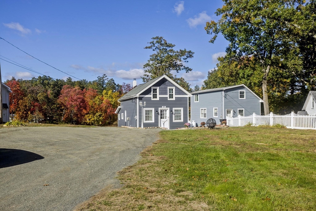 87 Pequot Point Road Westfield, MA 01085 - Photo 6 of 42 a front view of a house with a yard and garage