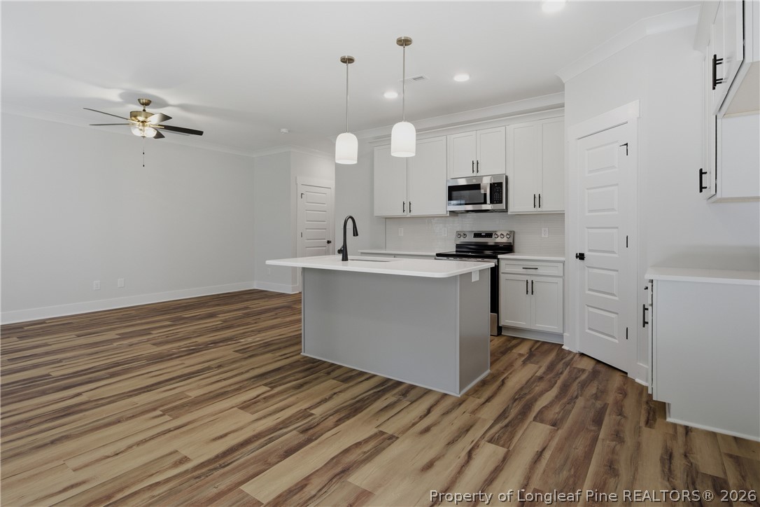 3931 Hamilton Street Hope Mills, NC 28348 - Photo 20 of 50 a kitchen with a sink cabinets and wooden floor