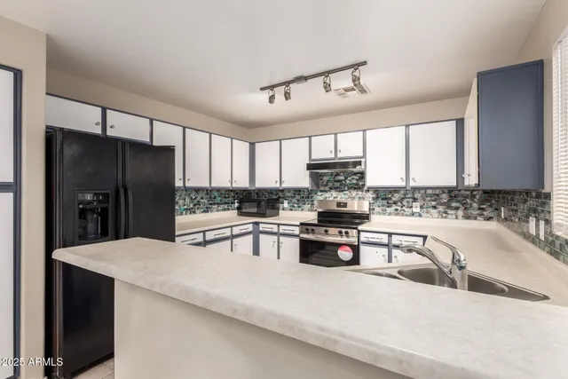 a view of a kitchen with a sink and stainless steel appliances