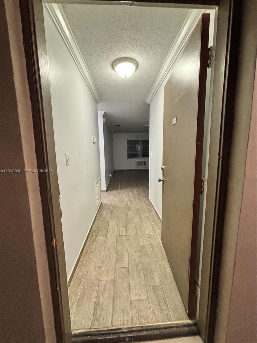1480 East Sample Road, Unit 209 Pompano Beach, FL 33064 - Photo 7 of 24 a view of a hallway with wooden floor and staircase