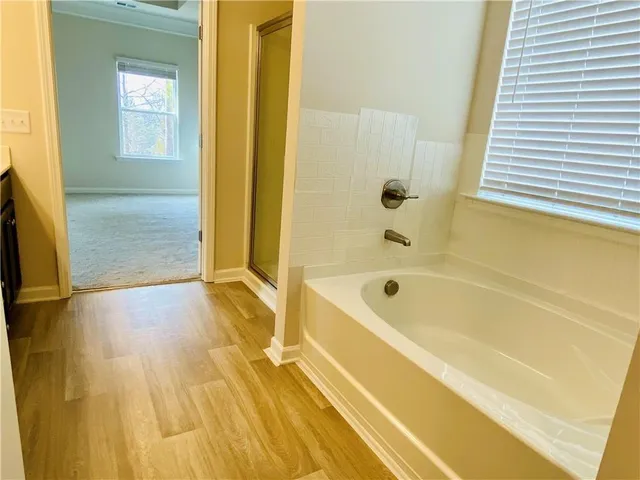 a spacious bathroom with a bathtub and shower