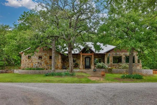 a front view of house with yard and green space