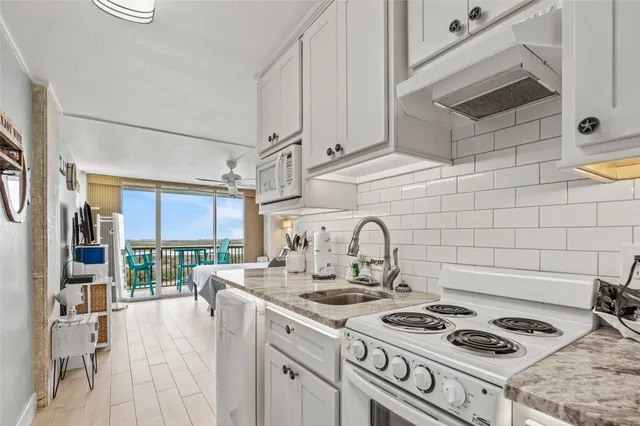 a kitchen with stainless steel appliances granite countertop a sink and cabinets