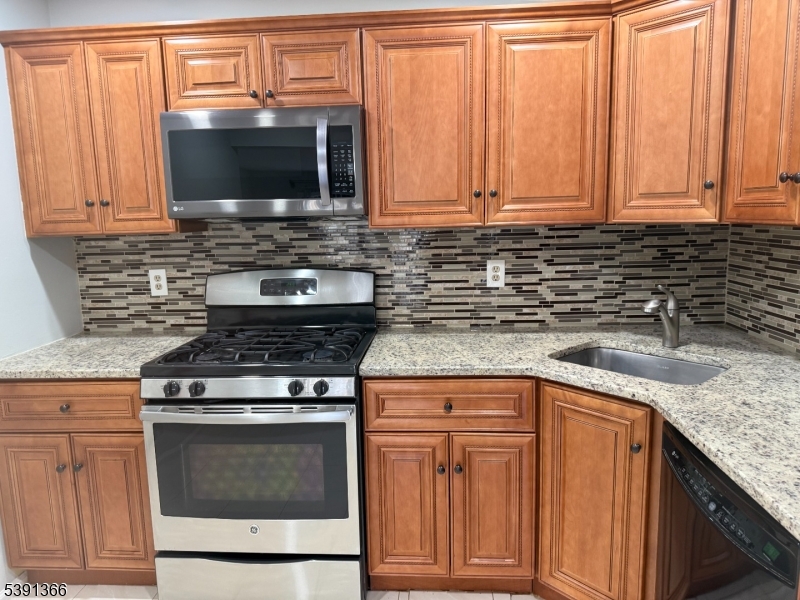 122 Irving Place Bernards, NJ 07920 - Photo 11 of 20 a kitchen with granite countertop a stove top oven cabinetry a sink and dishwasher