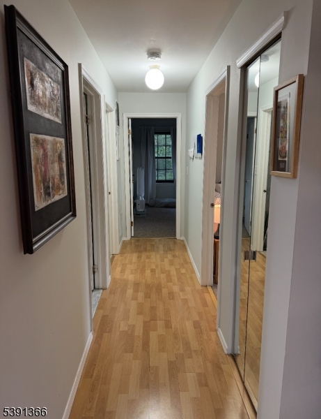 122 Irving Place Bernards, NJ 07920 - Photo 13 of 20 a view of a hallway with wooden shelves
