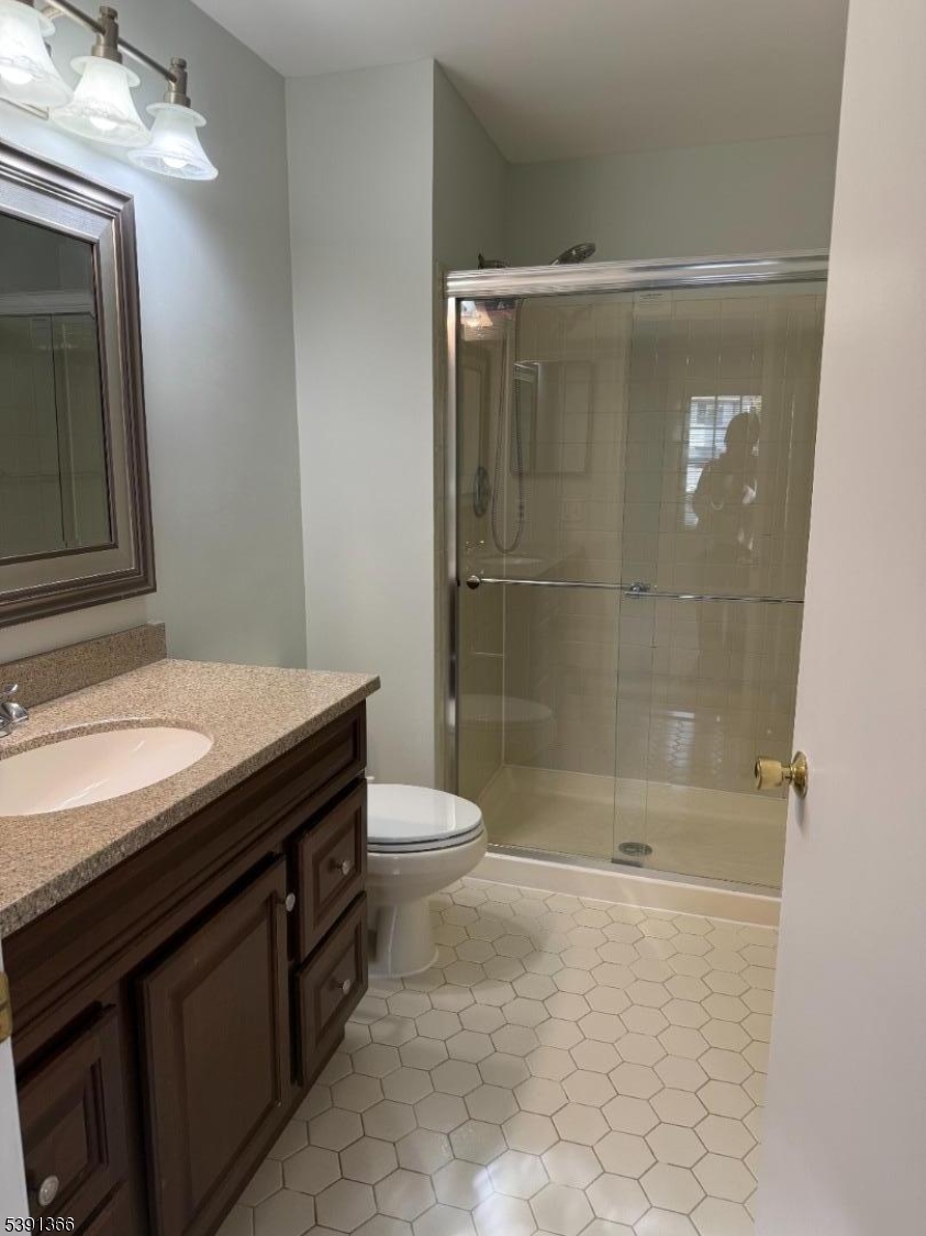 122 Irving Place Bernards, NJ 07920 - Photo 16 of 20 a bathroom with a granite countertop sink a toilet and shower