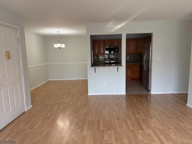 a kitchen with stainless steel appliances granite countertop a refrigerator stove and microwave