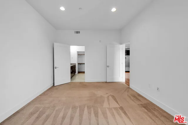 a spacious bathroom with a granite countertop sink and a mirror