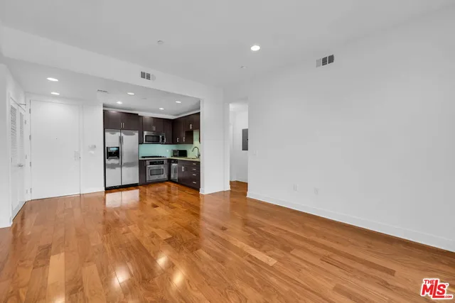 a living room with furniture a flat screen tv and a large window